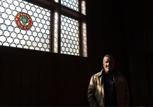 In this March 24, 2014 photo Jim Haertel stands in an upper floor of the former administrative building for Pabst brewery in Milwaukee. He bought that building and another one in 2001. He supports an effort to try to raise money to bring the company's headquarters back to Milwaukee. (AP Photo/Carrie Antlfinger)