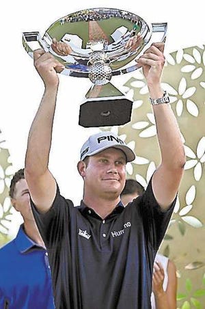 Harris English, from the U.S., holds his trophy after winning the OHL Classic at Mayacoba golf tournament in Quintana Roo, Mexico, Sunday, Nov. 17, 2013. (AP Photo/Christian Palma)