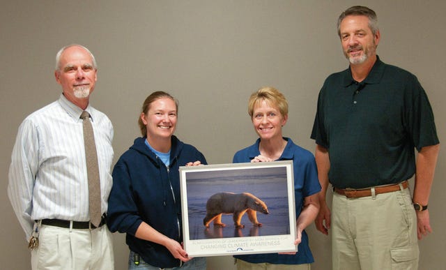 N.C. Zoo representatives present the 'Paw of Approval' to MOM Brands for its conservation efforts on Friday. Displaying the Award are, from left, Ken Reininger, the zoo's general curator, and Sara Monson, polar bear keeper, along with left, Lisa Withrow, sanitation manager for the Asheboro plant, and Dale Ducommun, MOM plant manager. (Paul Church/The Courier-Tribune) 
 Montgomery County Schools receives 'Paw of Approval" award at Candor Elementary School. (Montgomery County Schools photo)