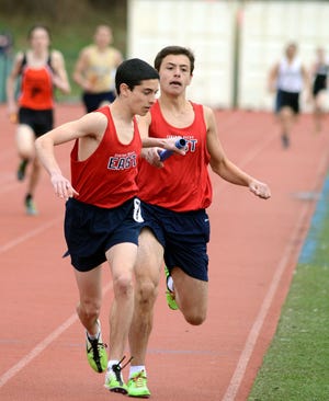 NEWTOWN, PA - APRIL 5: Central Bucks East runners trade the baton as they compete in the 400 meter relay at the Council Rock Kiwanis Invitational boys track and field meet April 5, 2014 in Newtown, Pennsylvania.(Photo by William Thomas Cain/Cain Images)