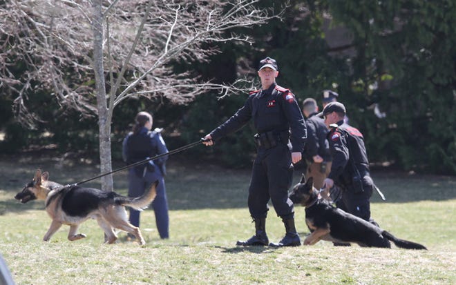 State police K-9 units search the URI campus in April 2013 during a sweep.