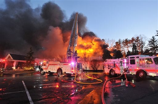 Firefighters respond to a multiple alarm fire at the popular Lakeview Pavilion in Foxboro, Mass., Saturday, April 5, 2014. A wedding was taking place at the time of the fire.
