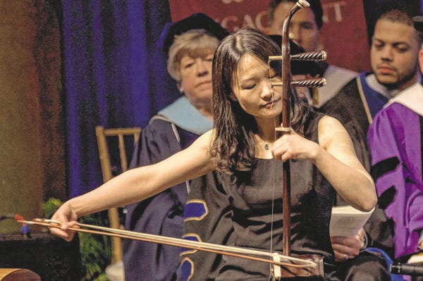 Courtesy of UMass Dartmouth
Dr. Jing Wang plays the erhu, a Chinese indigenous string instrument, at the inauguration of UMass Dartmouth Chancellor Divina Grossman. Dr. Wang has been named a McDowell Fellow.