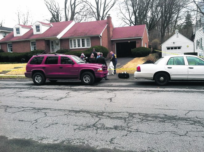 Investigators gather Saturday at the home Audrey Carpino, 86, shared with her 53-year-old son, Mark Carpino, at 122 West Chester St. in Kingston. Audrey Carpino was found dead in her bedroom.