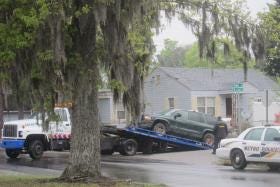 The Dodge Durango that was stolen with a child inside Sunday morning while being used to deliver newspapers in Savannah is towed away from 62nd and Meding streets after being recovered by police. (Dash Coleman/Savannah Morning News)