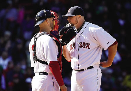 Boston Red Sox catcher David Ross, left, speaks with starting pitcher Jon Lester after Lester gave up a hit in the seventh inning of their game against the Milwaukee Brewers on Sunday in Boston. The Brewers shut out the Red Sox, 4-0.