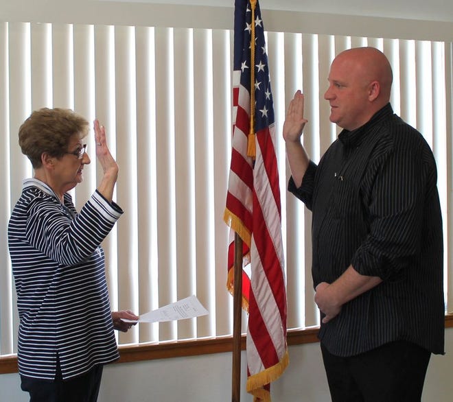 Chillicothe Township Clerk Sharon Crabel, left, administers the oath of office March 31 to her son Shawn Crabel as he becomes the Chillicothe Township Assessor. His first day was April 1.