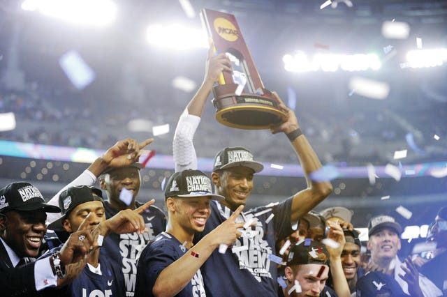 Shabazz Napier makes the sign that he has won 2 national championships as the Connecticut Huskies beat the Kentucky Wildcats 60-54 in the NCAA Final Four championship game at AT&T Stadium in Arlington, Texas, Monday, April 7, 2014. (Stephen Dunn/Hartford Courant/MCT)
