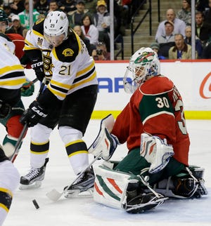 Wild goalie Ilya Bryzgalov (30) deflects a shot in front of Bruins winger Loui Eriksson during the second period.