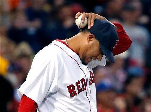 Red Sox starting pitcher Felix Doubront reacts on the mound after giving up runs to the Texas Rangers in the third inning of Tuesday's game.