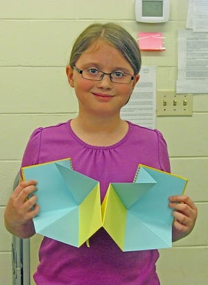 Fourth-grader Emily shows off a poetry book she made at the Great Stone Face book discussion group held Thursday afternoons at North Hampton Public Library.
Courtesy Photo