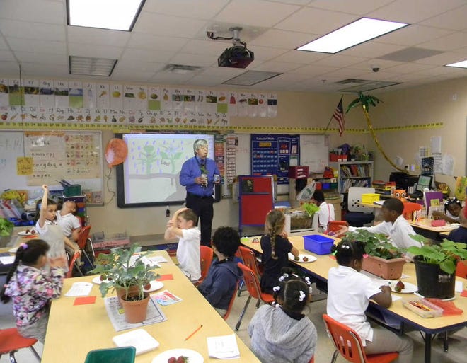 Horace Horgroves teaches his students at Pulaski Elementary about photosynthesis and how plants make energy. The students have been raising a garden at the school since February. (Katie Martin/Savannah Morning News)