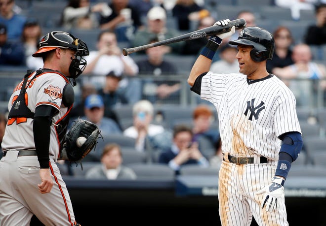 Baltimore catcher Matt Wieters, left, retreats to the dugout Tuesday as New York's Derek Jeter reacts after being called out on strikes during the Yankees' 14-5 loss. THE ASSOCIATED PRESS