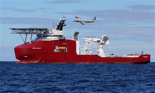 In this April 9, 2014 photo provided by the Australian Defense Force, a Royal Australian Air Force AP-3C Orion flies past Australian Defense vessel Ocean Shield on a mission to drop sonar buoys to assist in the acoustic search of the missing Malaysia Airlines Flight 370 in the southern Indian Ocean.