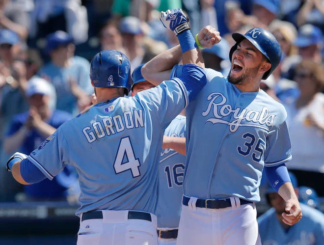 Kansas City Royals' Alex Gordon (4) is congratulated by teammate Eric Hosmer (35) after his three-run home run during the fifth inning of Wednesday's game against the Tampa Bay Rays at Kauffman Stadium.