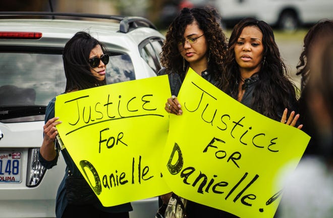 Family members of Danielle Locklear holds up a signs outside of the Cumberland County Detention Center on Wednesday, after the first appearance of Je'Michael Malloy and Dominic Tayvon Lock, who are charged with the second-degree murder.