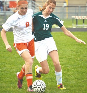 Cheboygan's Mandy Paull (left) battles for the ball against a Clare player during a game last season. Paull, now a junior, will be looking to lead the Chiefs to more success this season.