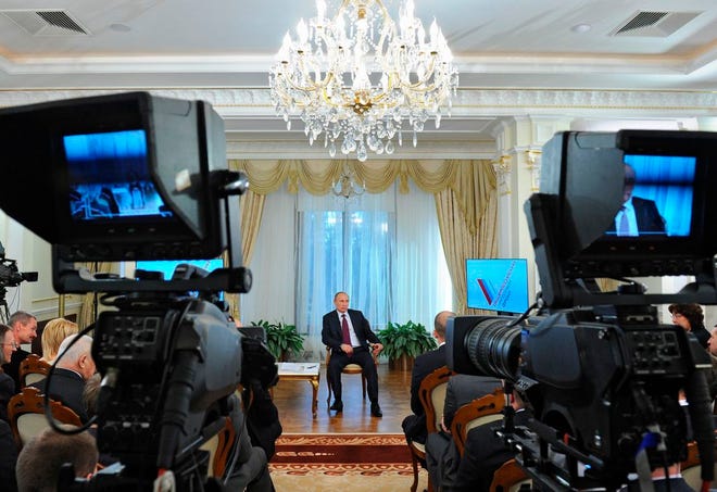 Russian President Vladimir Putin speaks during a meeting with the People's Front activists in the Novo-Ogaryovo residence outside Moscow on Thursday, April 10, 2014. Vladimir Putin has reached out to European leaders to discuss Ukraine's growing gas debt to Moscow, according to the Russian president's press secretary. (AP Photo/RIA-Novosti, Mikhail Klimentyev, Presidential Press Service)