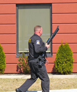 A state trooper patrols the Hampton Inn parking lot during Thursday's incident.