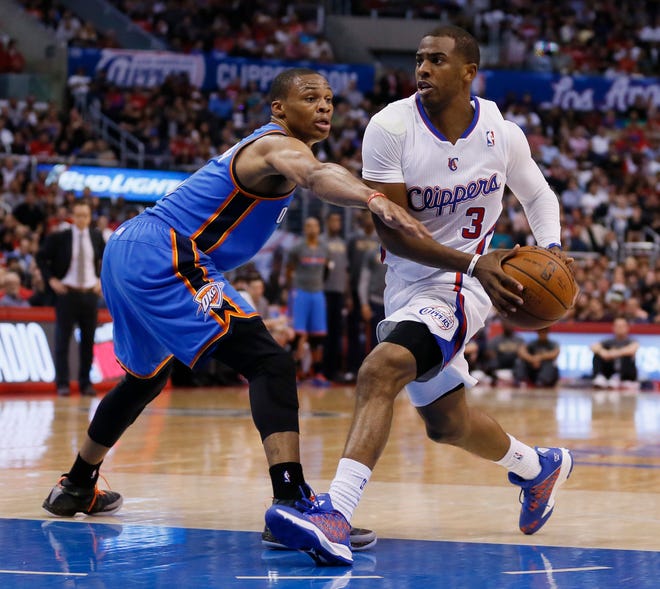 Clippers guard Chris Paul, right, drives past Thunder guard Russell Westbrook during the first half Wednesday in Los Angeles. 
         AP Photo