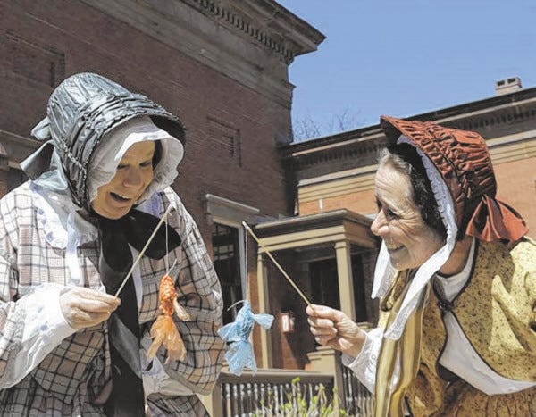 Courtesy of New Bedford Whaling National Historical Park
Abby (Judy Roderiques) and Ruth (Lucy Bly) admire little fish fashioned from plastic bags. The national park role players will lead a craft using recycled materials at tonight’s “Sustainable SouthCoast” AHA!