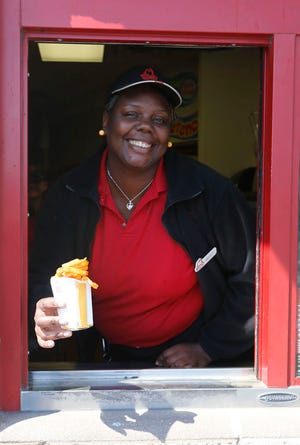 Laurette Simmons hands out an order of curly fries at the Arby’s in New Bern. The restaurant is one of several area businesses that will be giving away tax day freebies to ease the pain of paying your taxes.