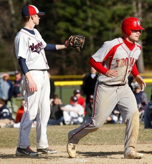 Lincoln-Sudbury pitcher Owen Bautze (left) waits for the catcher to retrieve the ball as Bridgewater-Raynham's Andrew Noviello crosses the plate on a wild pitch during the Warriors' 12-4 loss on Thursday afternoon.