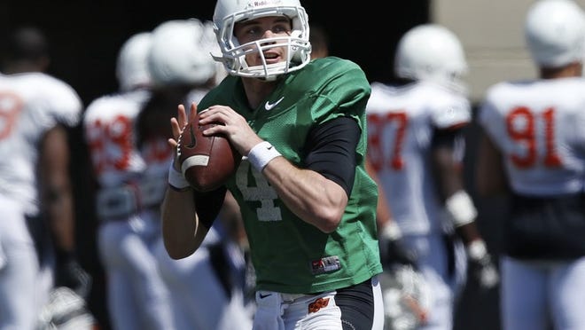 Oklahoma State quarterback J.W. Walsh passes during last Saturday’s spring practice open to the public in Stillwater, Okla.