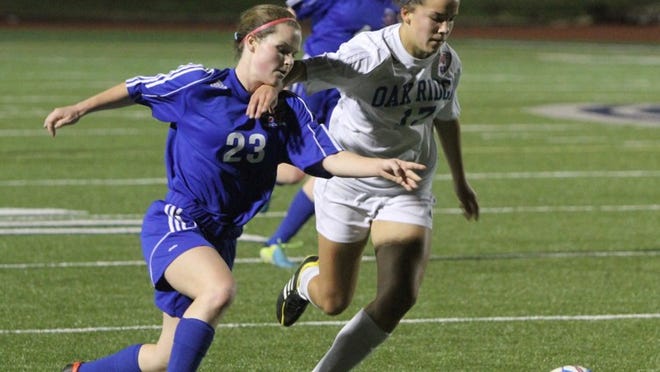Westlake’s Margaret Norman (23) fights with an Oak Ridge player for possession during Westlake’s area playoff game with Oak Ridge at Viking Stadium in Bryan on April 4, 2014. Norman scored the lone goal in Westlake’s 2-1 loss in the regional quarterfinals.