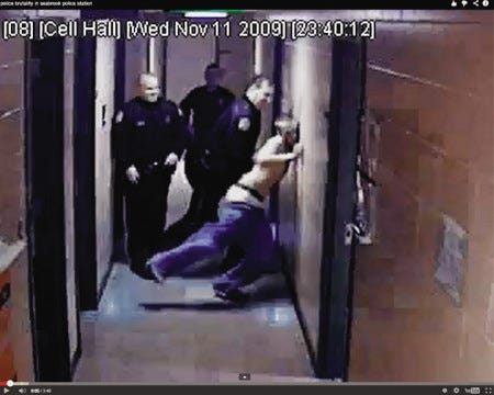Michael Bergeron Jr. is slammed into a wall at the Seabrook Police Department, as seen in this image from a 2009 incident posted in a YouTube video.