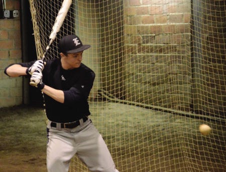 Ryan O’Leary photo 
Exeter High School senior James Mundy prepares to take a swing during a recent practice held in The Cage at Phillips Exeter Academy.