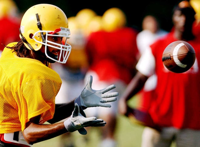Clarke Central wide receiver Micah Hurst catches a Nelson Browner pass in practice Tuesday, Sept 2, 2003. (File)
