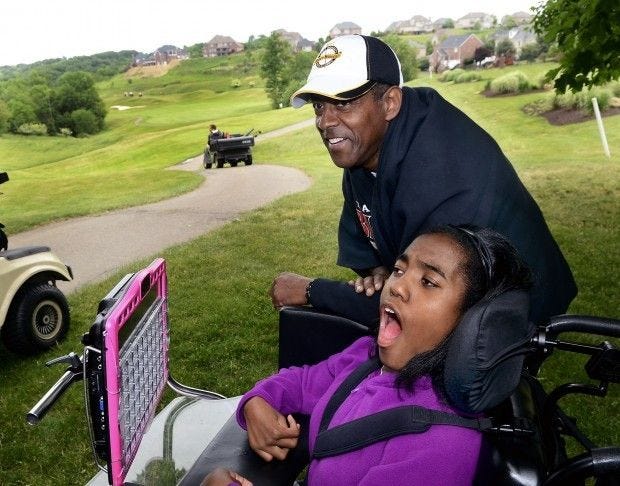 Tony Dorsett chats and has some fun with a fan during the 21st annual Tony Dorsett/McGuire Memorial Celebrity Golf Classicc in 2013. Dorsett will host the 25th anniversary of the event Monday, the first time he will host since being diagnosed with a brain injury in 2014.