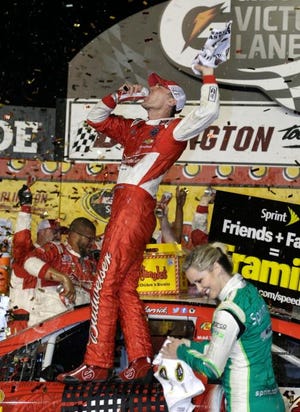 Kevin Harvick celebrates in Victory Lane after winning a NASCAR Sprint Cup series auto race at Darlington Raceway in Darlington, S.C., on Saturday night.