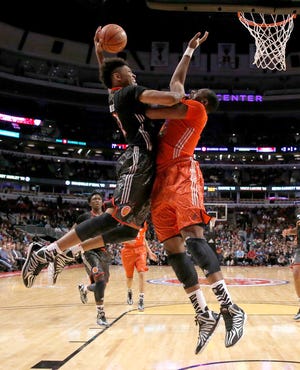 Kelly Oubre, left, goes up for a dunk over Cliff Alexander at the McDonald's All-American Game on April 2. Oubre and Alexander are both KU signees.