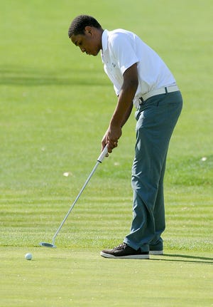 Burlington Township's Justin Murray putts during a match against Moorestown Monday afternoon at Burlington Country Club.