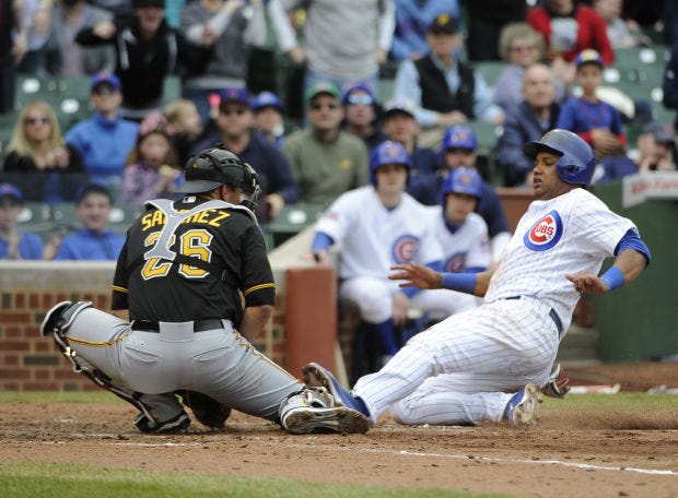 Chicago's Starlin Castro, right, is safe at home as Pirates catcher Tony Sanchez makes a late tag during the fourth inning of Thursday's game in Chicago.