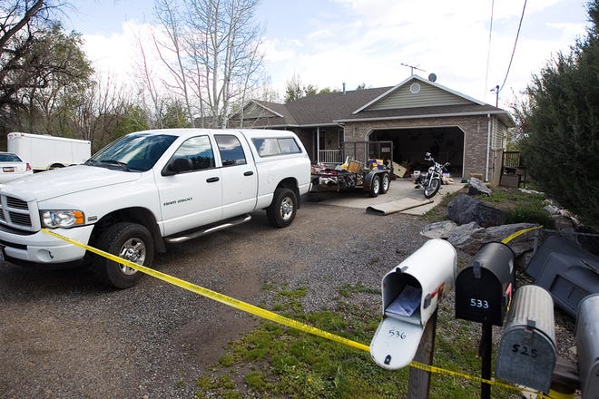 Authorities investigate a crime scene at a house in Pleasant Grove Utah, Sunday, April 13, 2014.