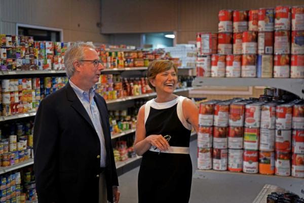 Steve Bisson/Savannah Morning News - Sam Olens, Georgia State Attorney General and Mary Jane Crouch, Executive Director of American's Second Harvest of Coastal Georgia, tour the warehouse following the campaign kickoff of the Georgia Legal Food Frenzy.