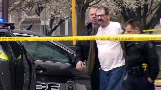 In this April 13, 2014, file image taken from video provided by KCTV-5, Frazier Glenn Cross is escorted by police in an elementary school parking lot in Overland Park, Kan. Authorities said Tuesday, April 15, that Cross has been charged with one count of capital murder for the deaths of a 14-year-old boy and his grandfather outside the Jewish Community Center of Greater Kansas City on Sunday. Cross also faces one count of first-degree, premeditated murder for the death of a woman who was gunned down while visiting her mother at a nearby retirement complex.KCTV-5/THE ASSOCIATED PRESS