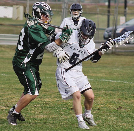Al Pike/Foster’s Daily Democrat
Ian Preston of St. Thomas, right, and Dover’s Cam Russell battle during Monday’s Division II lacrosse game in Dover.