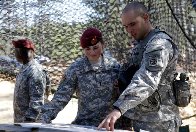 1st Lt. Kelly Requa speaks with Spc. Michael Cantrell, of Bravo Battery, 321st Field Artillery, at a fires direction center during certification at Fort Bragg, N.C.