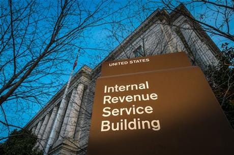 This April 13, 2014 file photo shows the headquarters of the Internal Revenue Service (IRS) in Washington. Tuesday, April 15, is the federal tax filing deadline for most Americans. (AP Photo/J. David Ake, File)