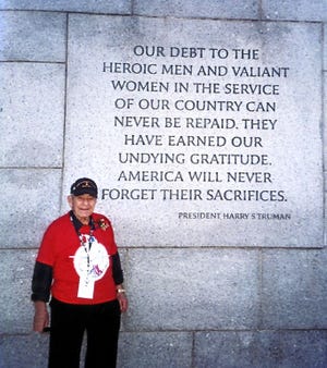 Joseph Gallo stands in front an inscription on the National World War II Memorial in Washington, D.C.