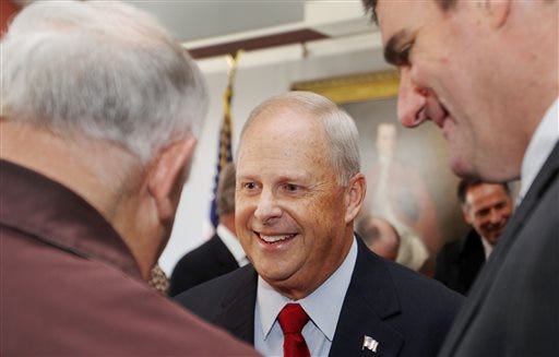 Former defense contractor and Republican, Walt Havenstein, center, talks with supporters after announcing that he is running for governor of New Hampshire, Wednesday April 16, 2014, in Concord, N.H.
