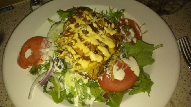 Sweet potato-encrusted swordfish served over a salad of mixed greens.