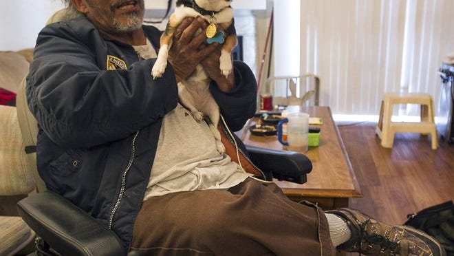 Daniel Apodaca, 60, and his dog, Keykey, sit in the one-bedroom, Southeast Austin apartment he leases with with the help of federal housing vouchers. Apodaca has struggled to find a new apartment, he said, because most of the apartment complexes he has visited won’t accept that form of federal housing assistance.