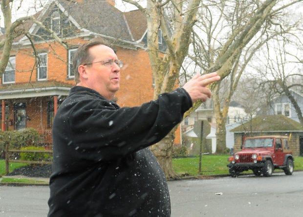 The Rev. Larry Reitz, pastor of College Hill United Methodist Church in Beaver Falls, points out the route of the Spring Walk and Roll amid surprise flurries April 15. The neighborhood event, hosted by five College Hill churches, will be held April 25.