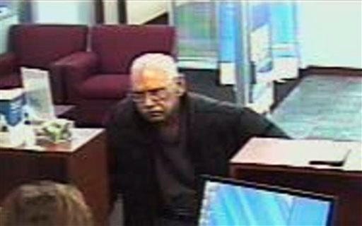 This Feb. 9, 2013 surveillance photo provided by the FBI shows 73-year-old Walter Unbehaun, an ex-convict from Rock Hill., S.C., during a bank robbery in Niles, Ill. Unbehaun allegedly told investigators he intended to get caught so he could live his final years behind bars.