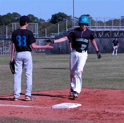 Destin eighth grader Ryan Romair rounds third base after slapping one over the left field fence in the second inning. He later cranked out another homer in the sixth inning.